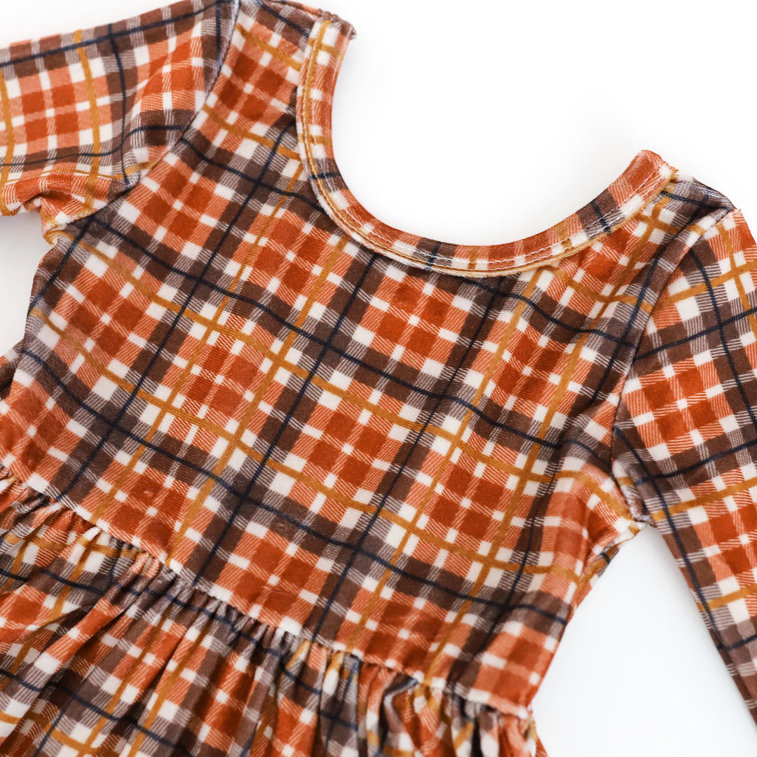 closeup view of girls' long sleeve velvet plaid twirl dress with harvest colors palette 