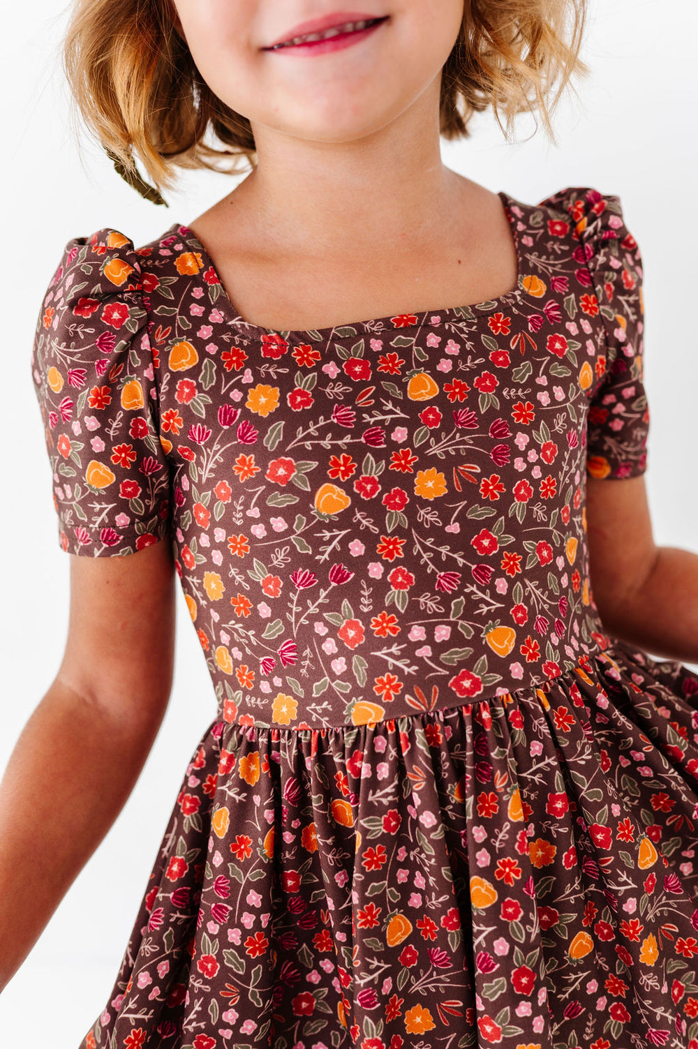 girl wearing brown floral dress for fall 2026
