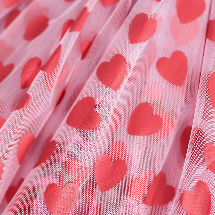closeup of red hearts printed on pink tulle skort for little girls' Valentines collection