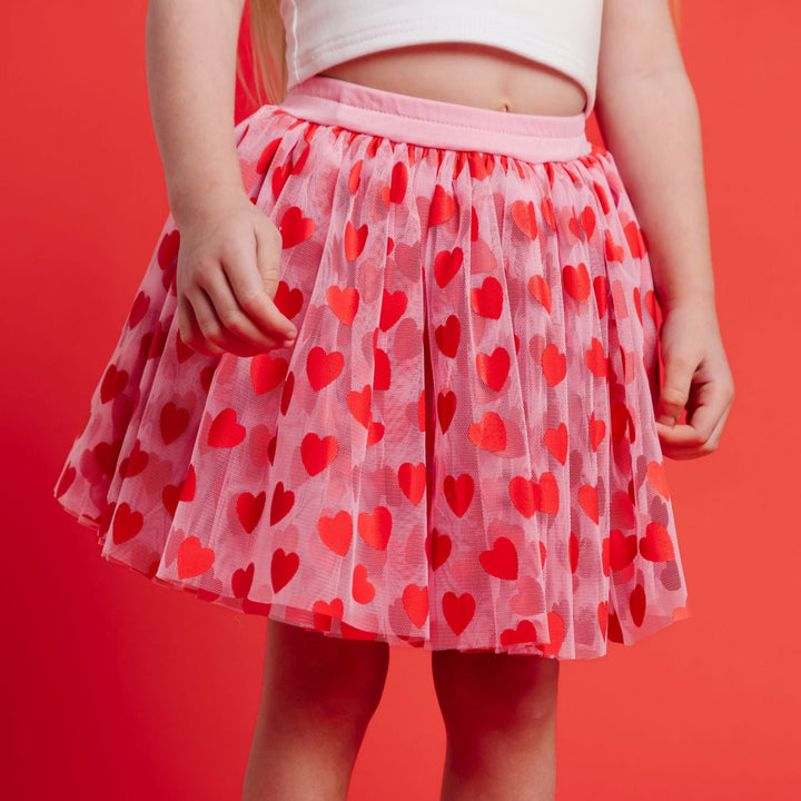 girl in light pink valentines tutu skort with red hearts and attached short
