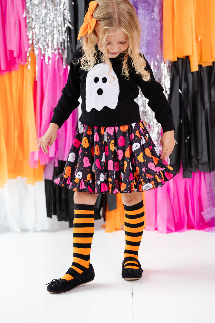 girls halloween outfit with black and orange striped knee high socks