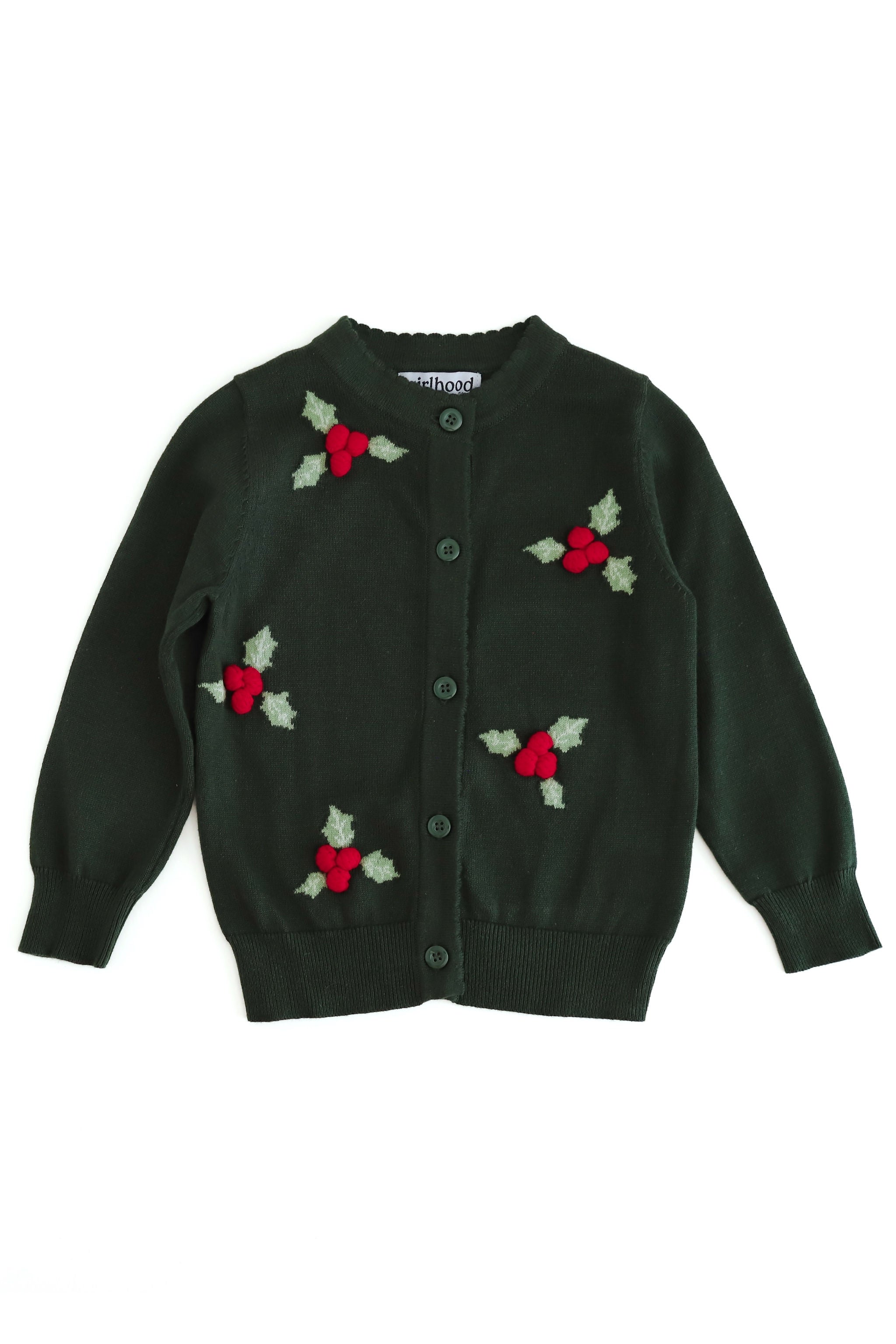 A dark green knit cardigan sweater with knit holly leaves and 3d red berries, featuring a button-up front and scalloped collar and placket. Ribbed cuffs, and hem.