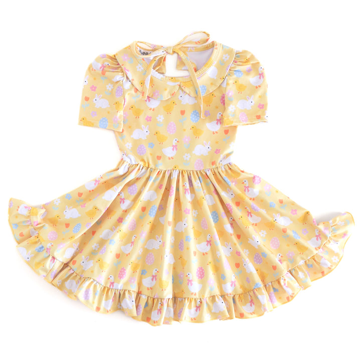 girls pastel yellow twirl dress with peter pan collar and Easter print featuring bunnies, chicks, geese and eggs
