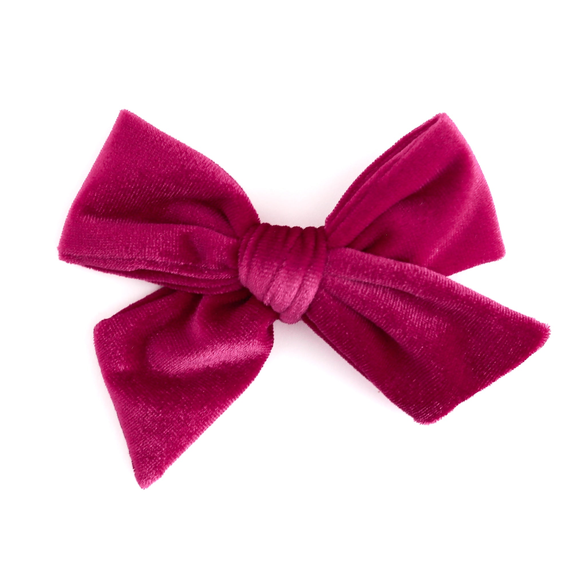 A hot pink velvet hair bow with a textured plush fabric, photographed against a solid white background.