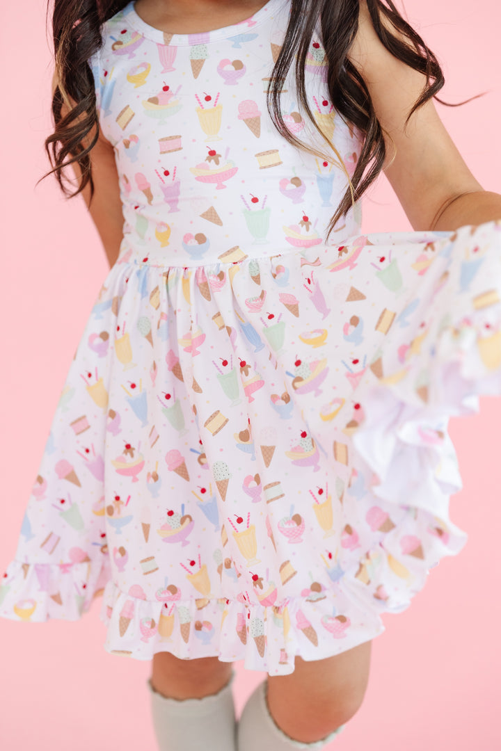 detail view of sleeveless twirl dress in white with pastel ice cream print 
