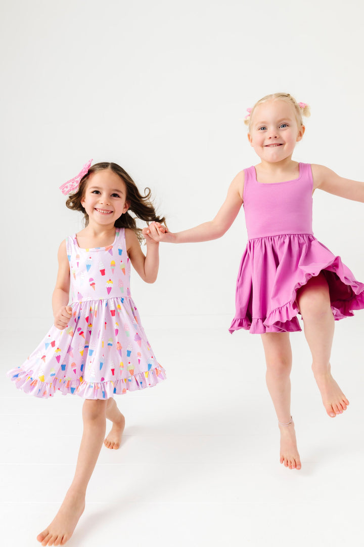 girls skipping in summer ice cream print and solid orchid sleeveless summer twirl dresses