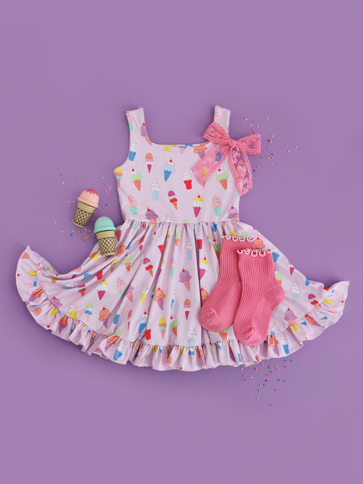 flat lay photo of girls' light purple tank twirl dress with colorful ice cream cone print paired with taffy pink midi socks and lace bow
