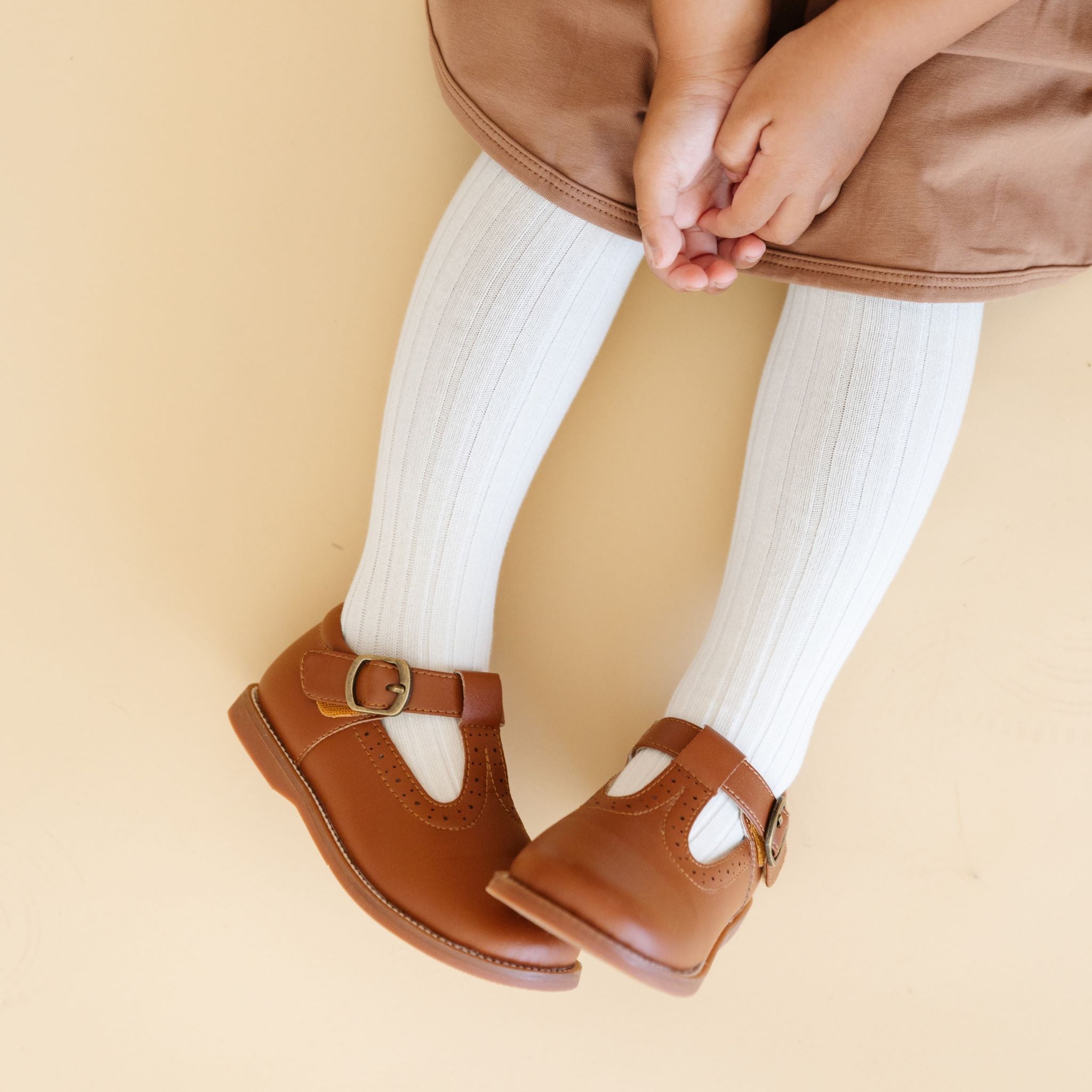 ivory ribbed cotton tights on little girl wearing brown leather shoes