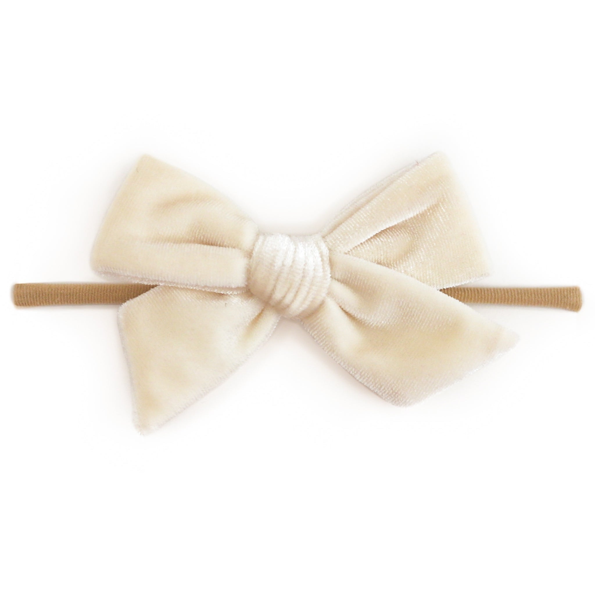 A cream-colored velvet bow headband with a textured white center and a tan elastic band, shown against a plain white background.