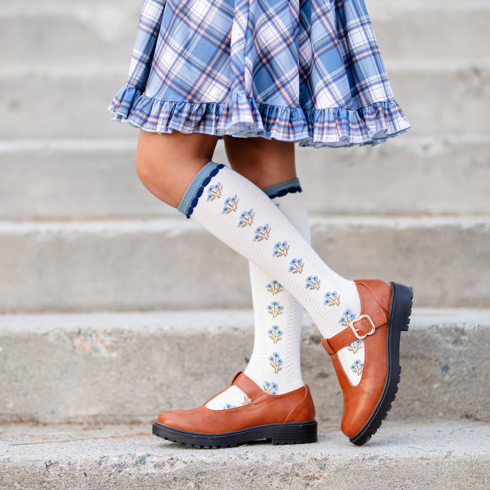 girl in ivory knee highs with denim embellishments and denim floral design paired with denim plaid twirl dress for fall