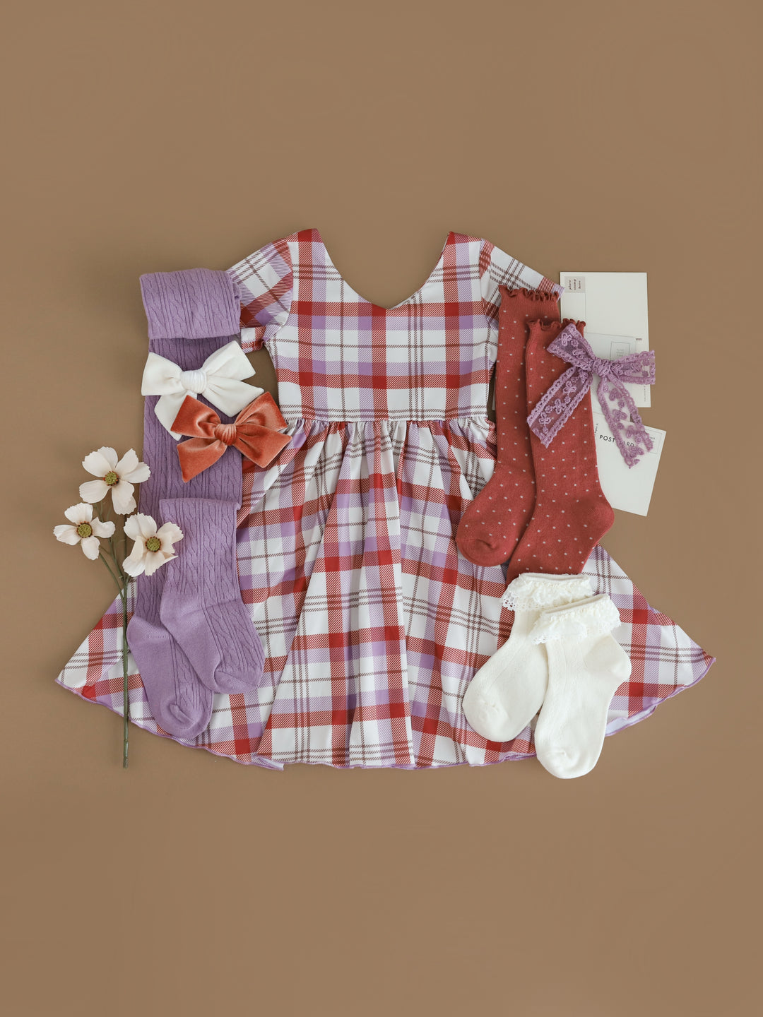 girls rust and purple plaid twirl dress on ivory paired with matching rust, ivory and amethyst socks and bows for fall