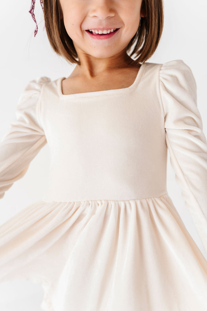 close up detail of girls ivory velvet square neck dress