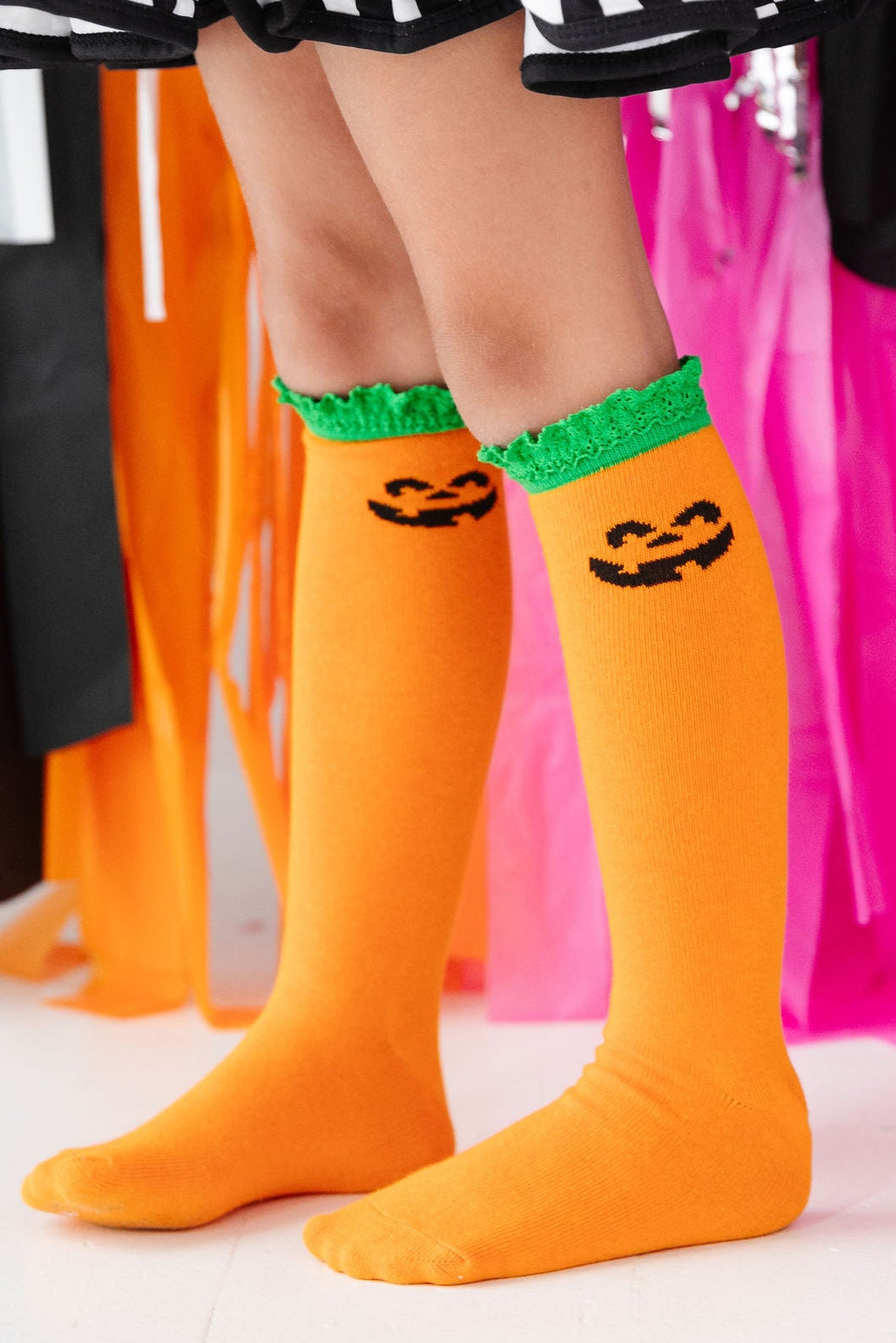 girl wearing jack-o-lantern halloween knee high socks with lace trim