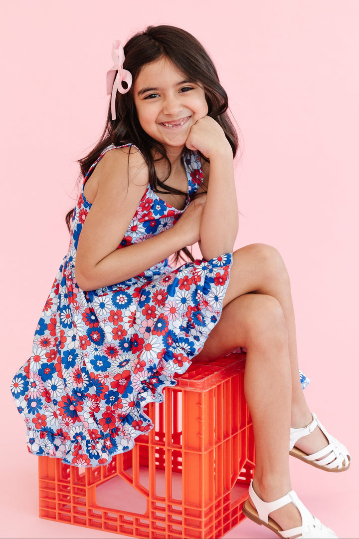 girl in floral sleeveless 4th of july summer twirl dress
