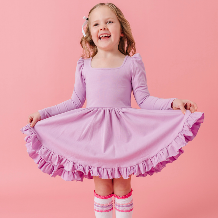 girl wearing purple twirl dress with matching knee high socks
