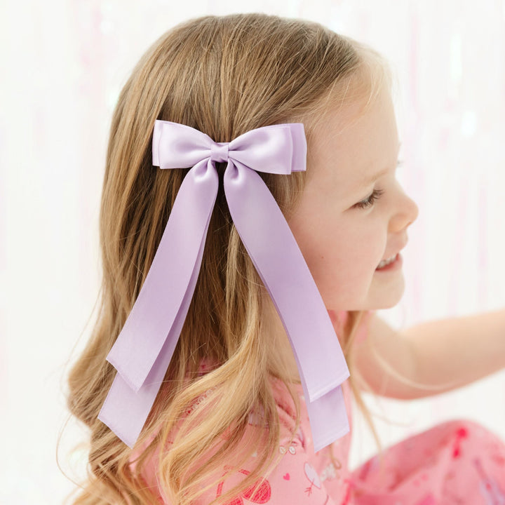 little girl in lavender satin long tailed ribbon bow and matching valentine's print dress