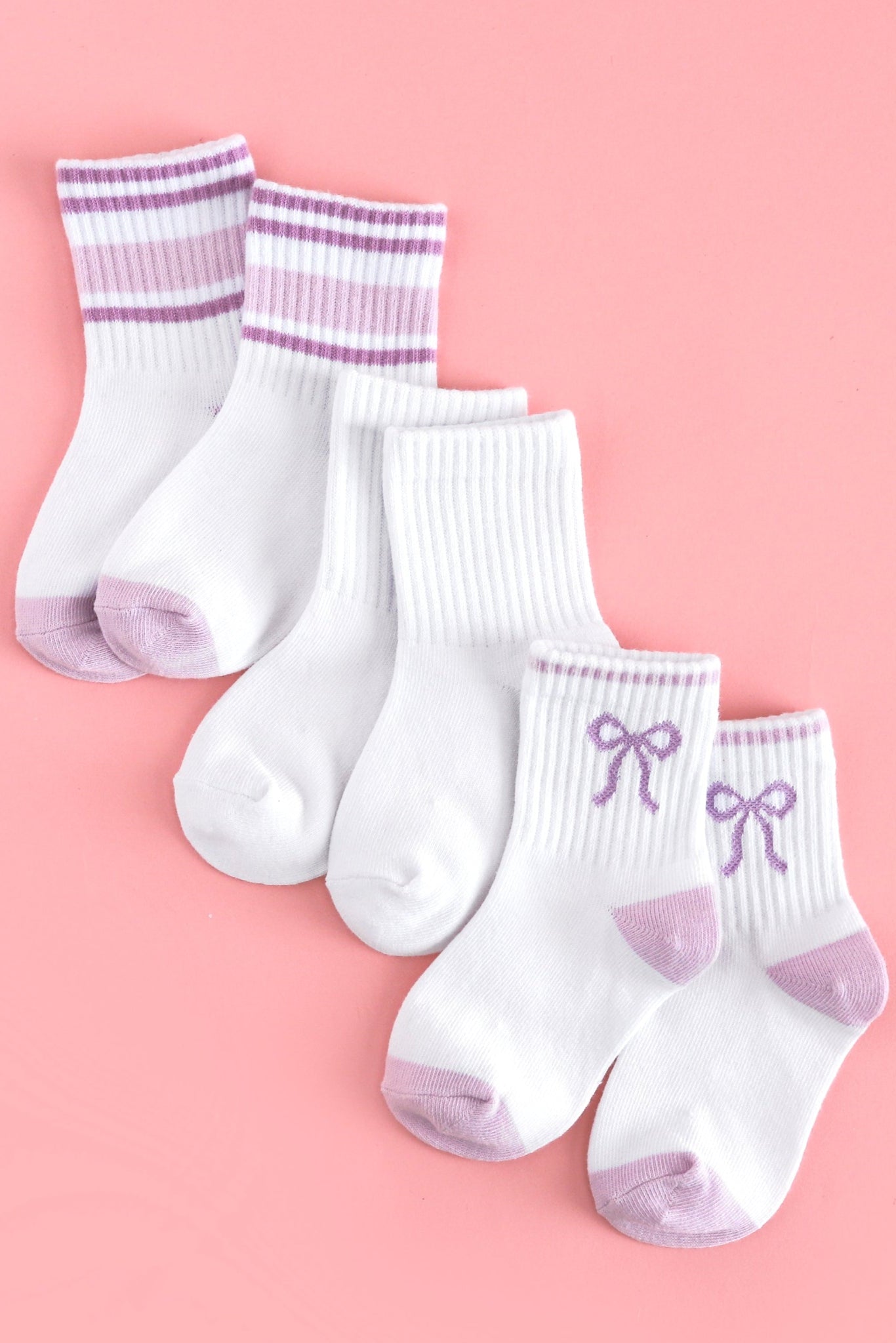 three pack of girl's summer midi crew socks: white with lavender bow design, solid white and white with pastel purple stripes