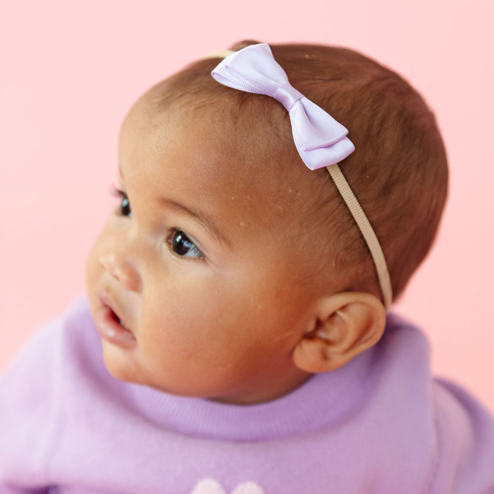 baby girl in lavender satin bow on nylon headband and matching lavender Valentine's Day sweater