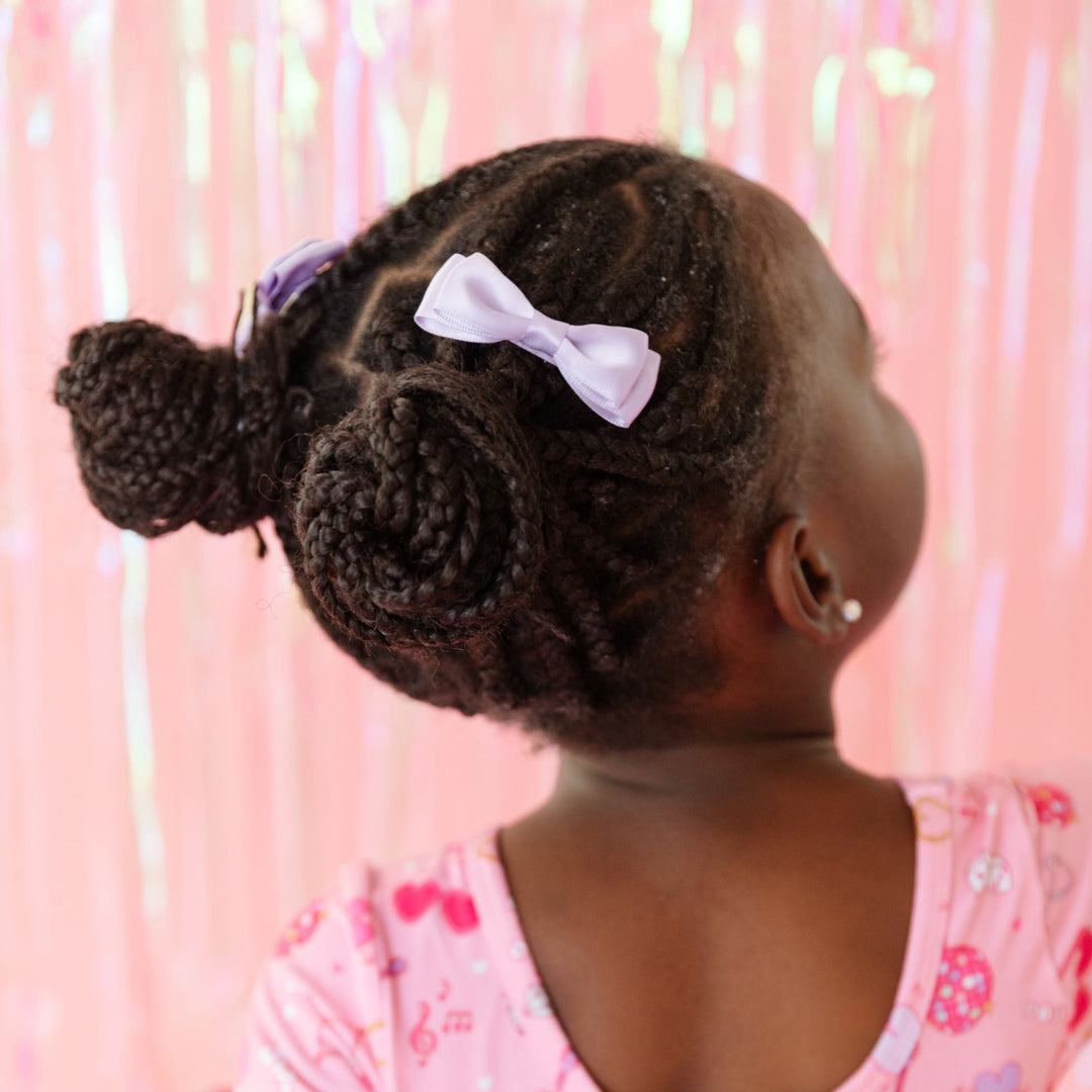 little girl in light purple satin pigtail bows for Valentine's Day