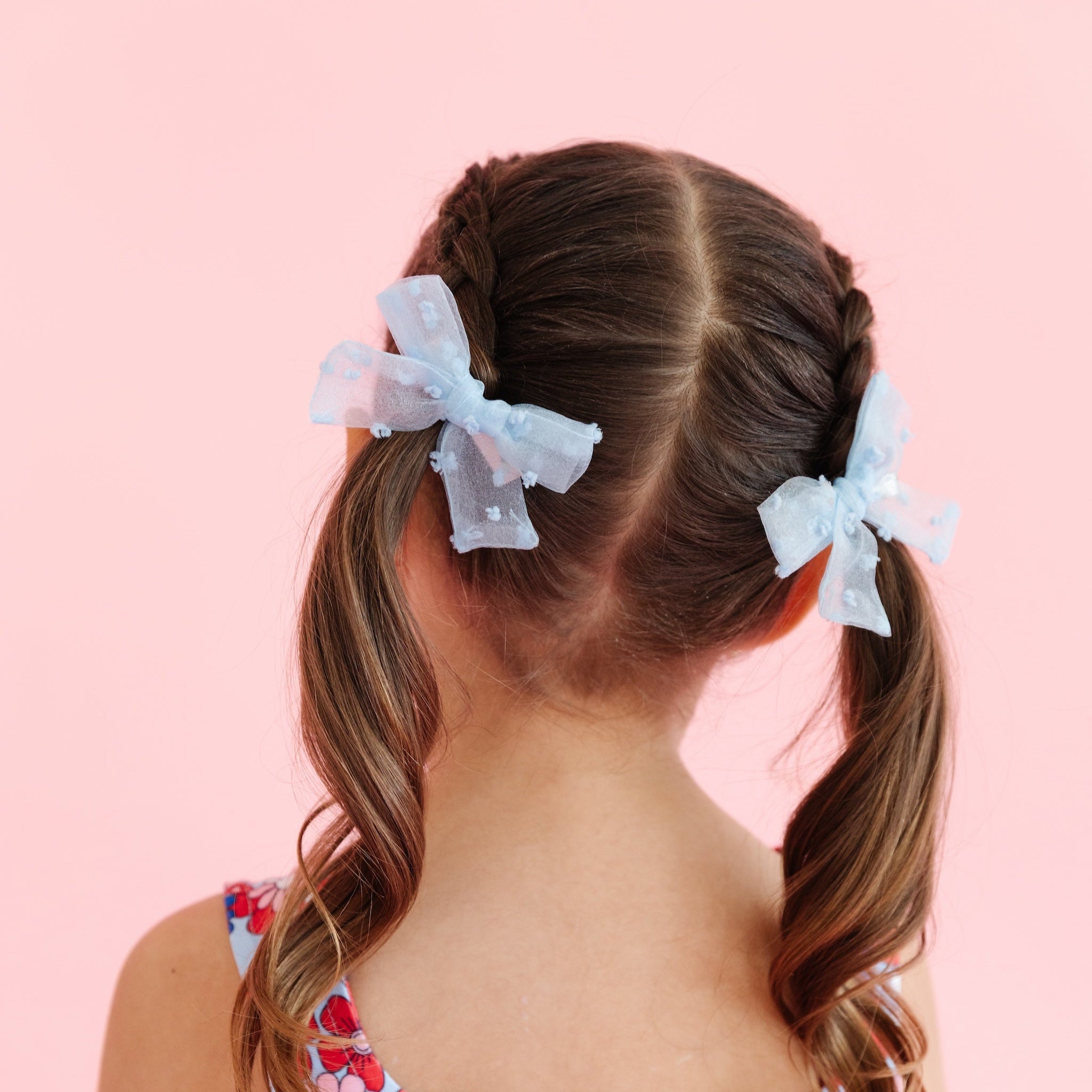 little girl wearing sheer light blue pigtail bows