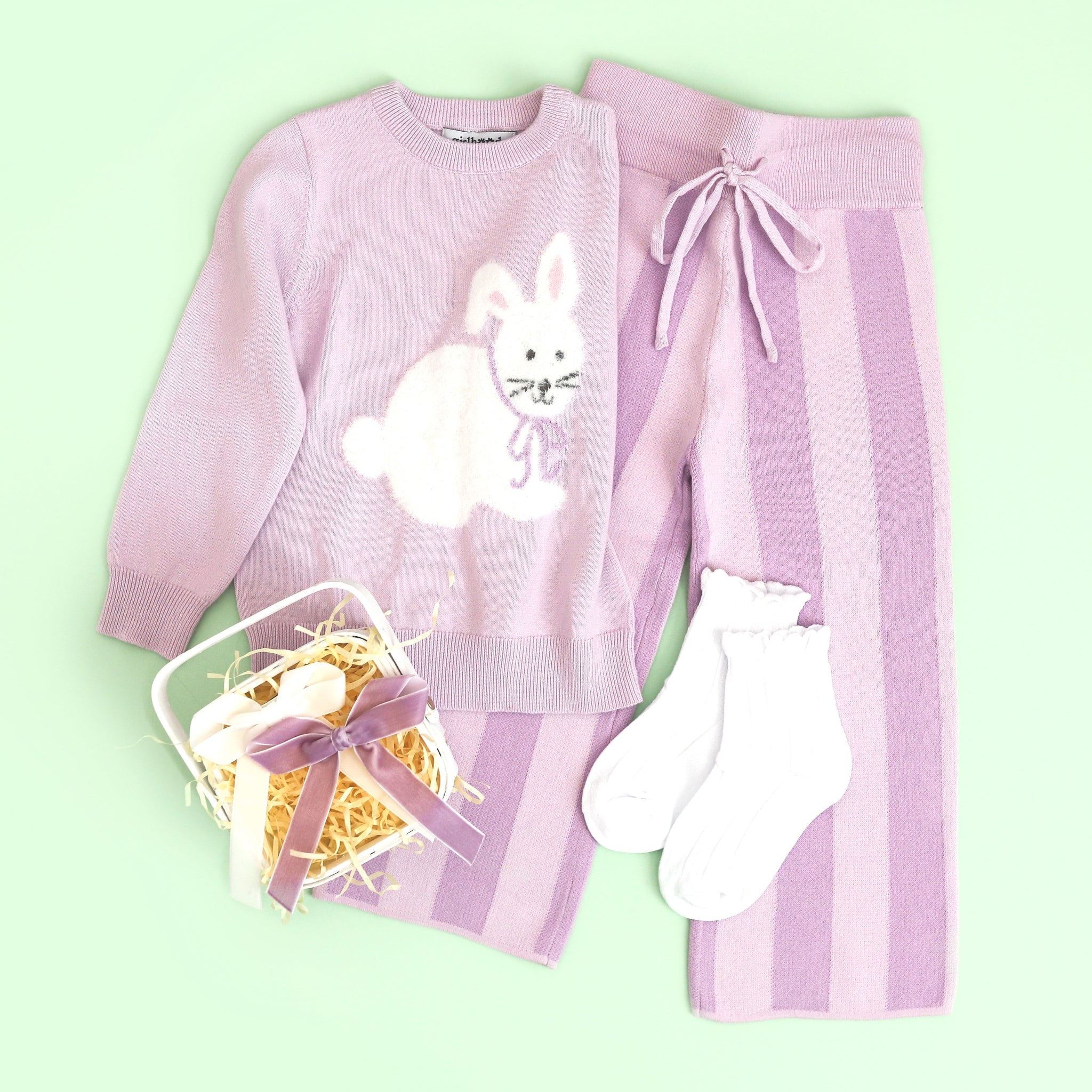 girl's pastel purple Easter sweater set with bunny pullover, purple striped pants, purple velvet bow and white midi socks