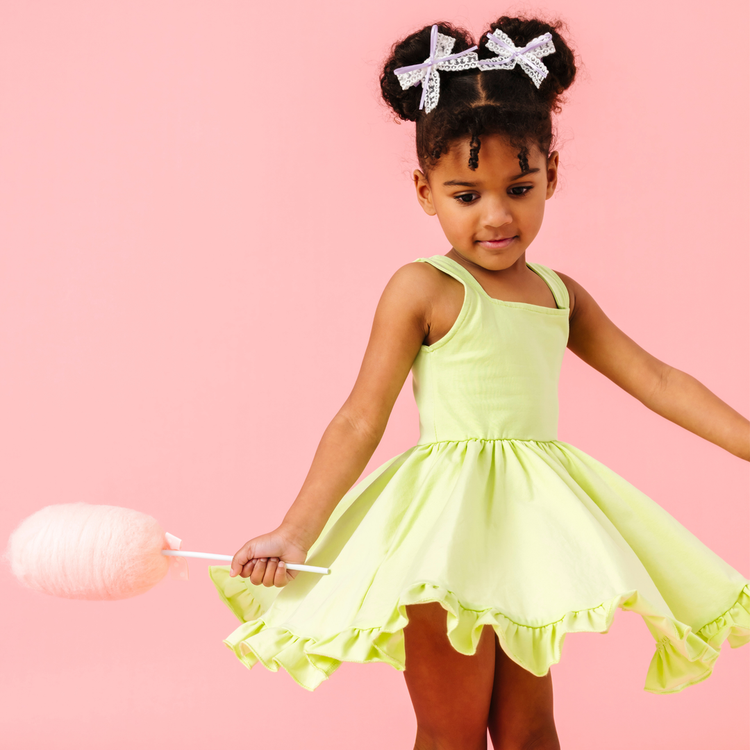 girl twirling in bright lime green summer dress