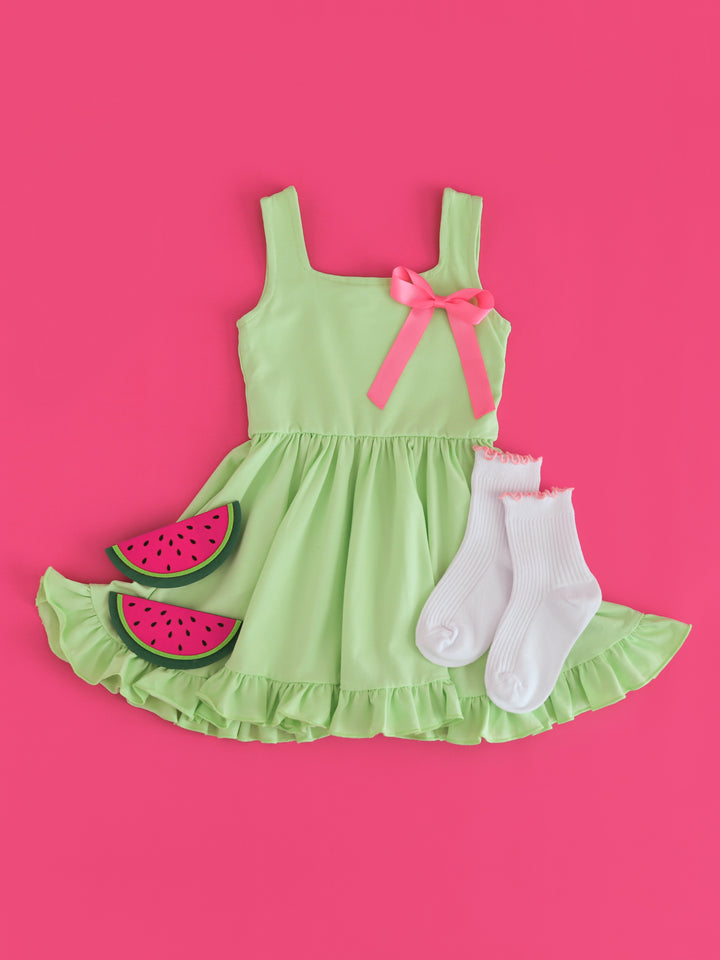 girls' lime green tank twirl dress styled with watermelon vibes with taffy pink satin hair bow and white ribbed midi socks with blossom lettuce trim