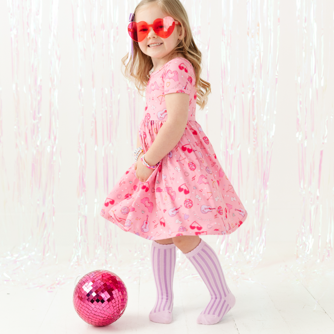 giril in swiftie valentine's day dress with lover heart glasses and disco ball