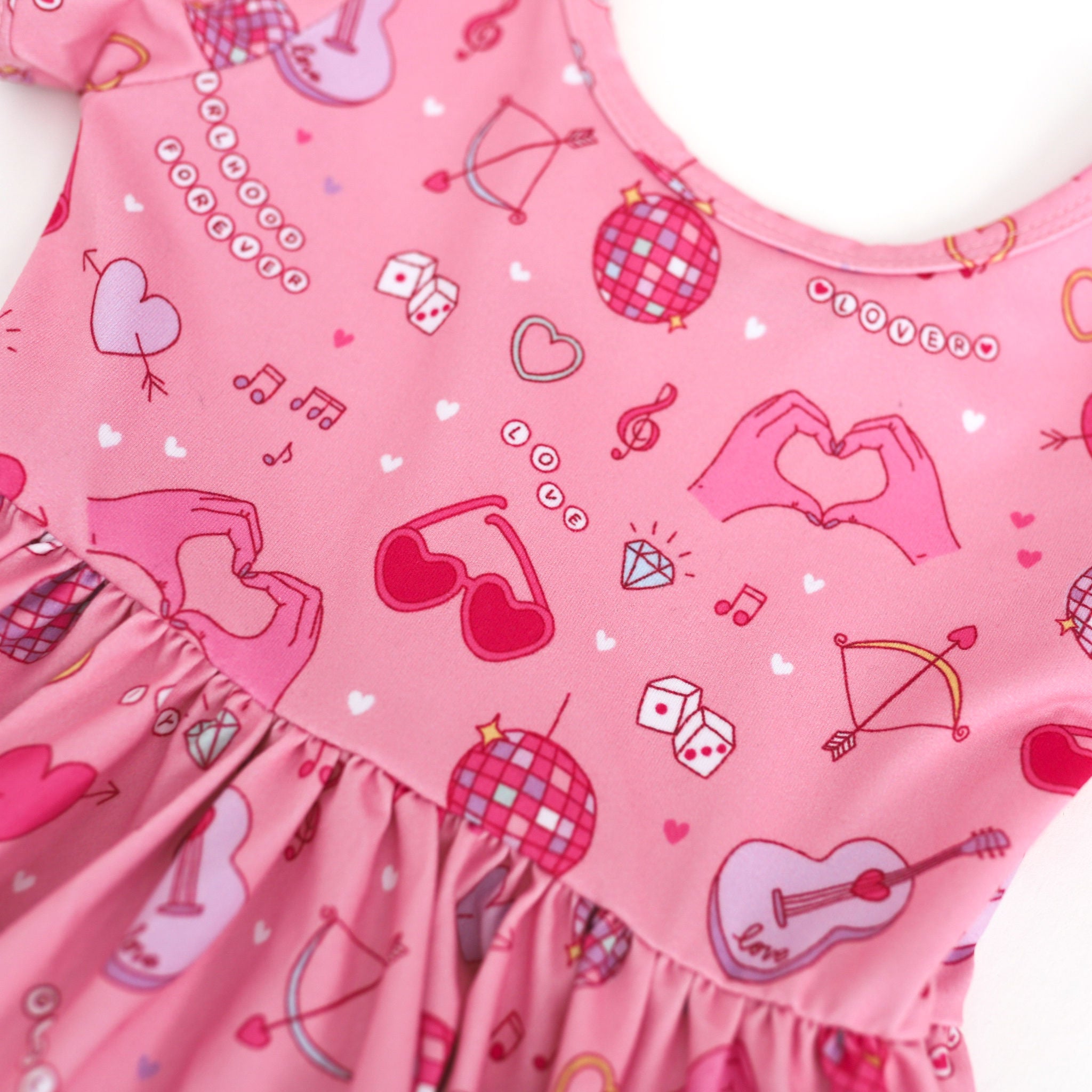 print closeup of pink twirl dress with iconic Valentine's day art