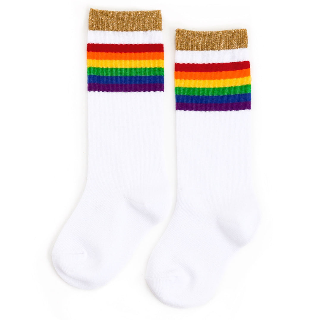 white knee high sock with rainbow stripes and sparkly gold band