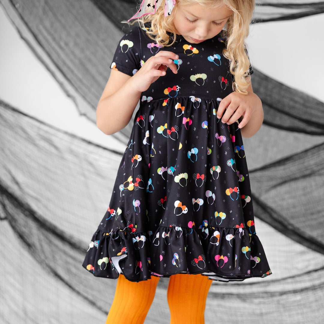 girl in mouse ear dress and orange tights