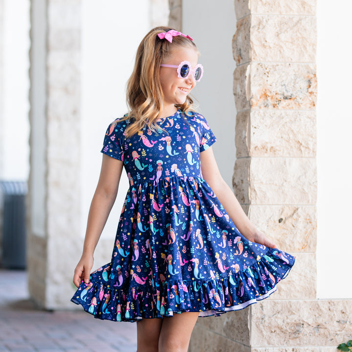 mermaid print dress on girl wearing sunglasses and pink hair bows