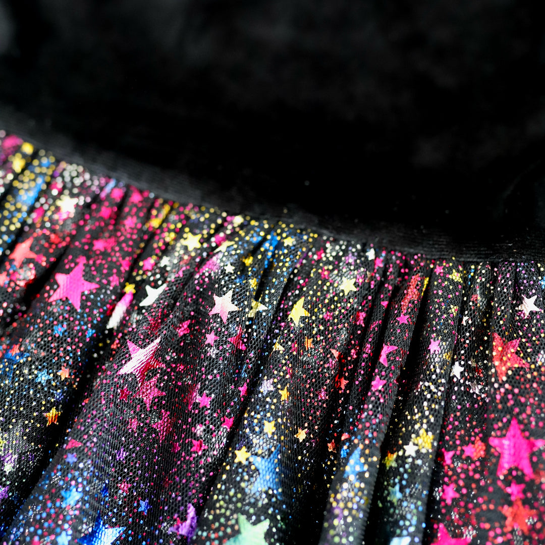 detail photo of girls party dress with black velvet on top and black tulle with rainbow metallic stars on bottom