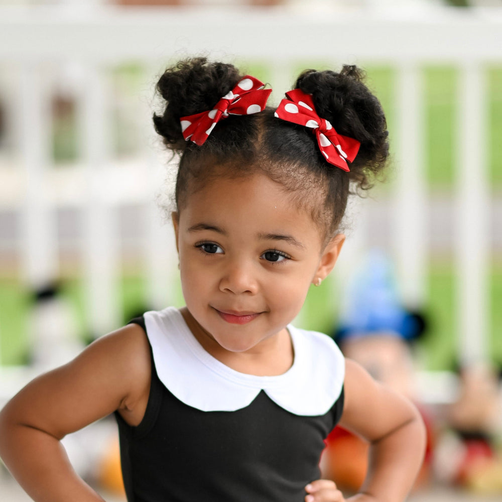 girl wearing red with white polkadot minnie inspired pigtail bows on clips