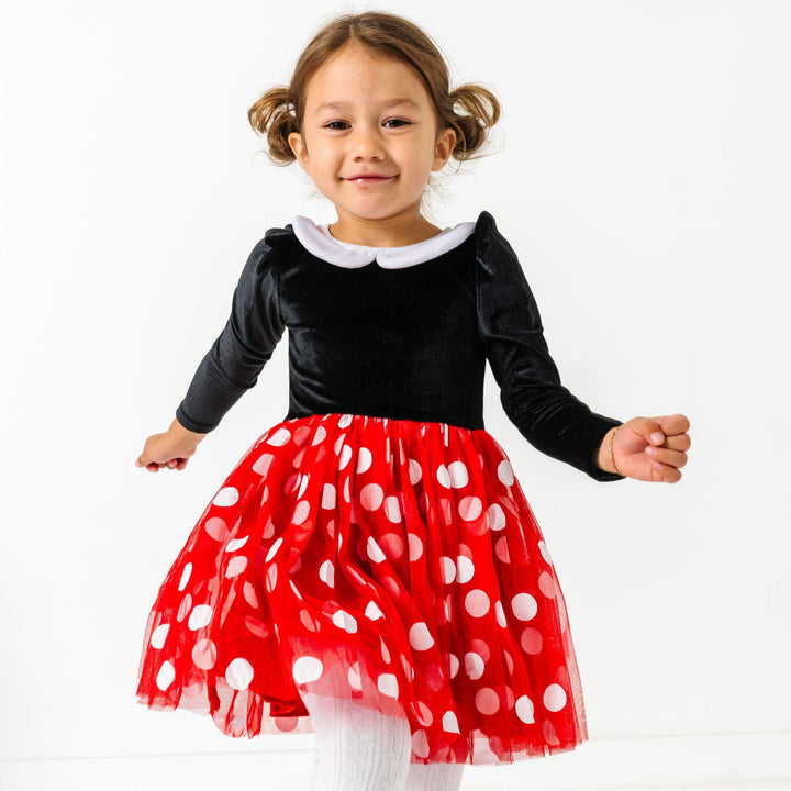 little girl in Minnie inspired long sleeve velvet dress with white collar and red tulle skirt with white polka dots