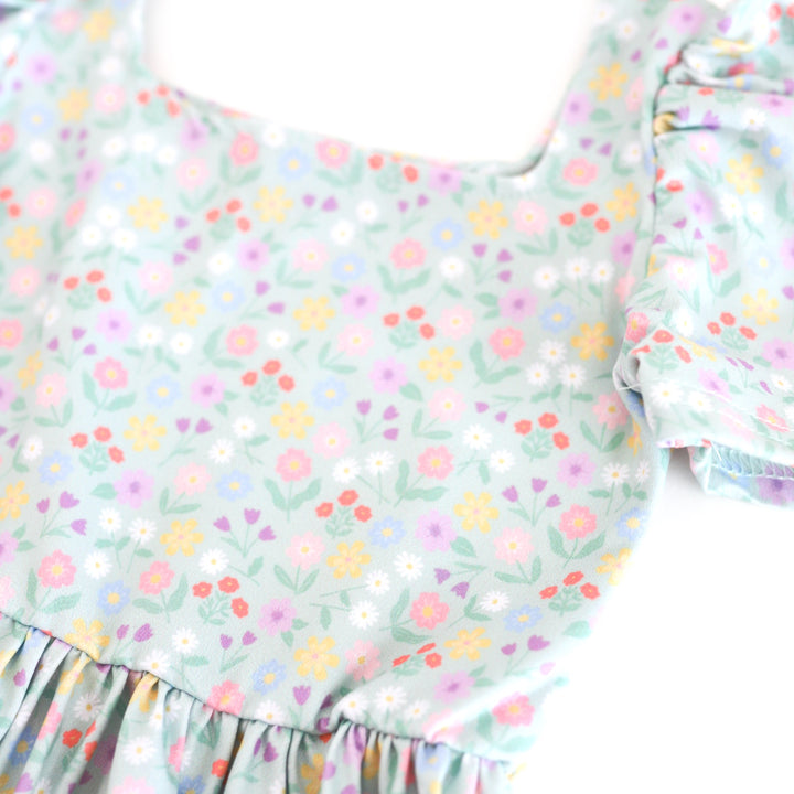 closeup of spring floral twirl dress print with soft mint background and pastel flowers