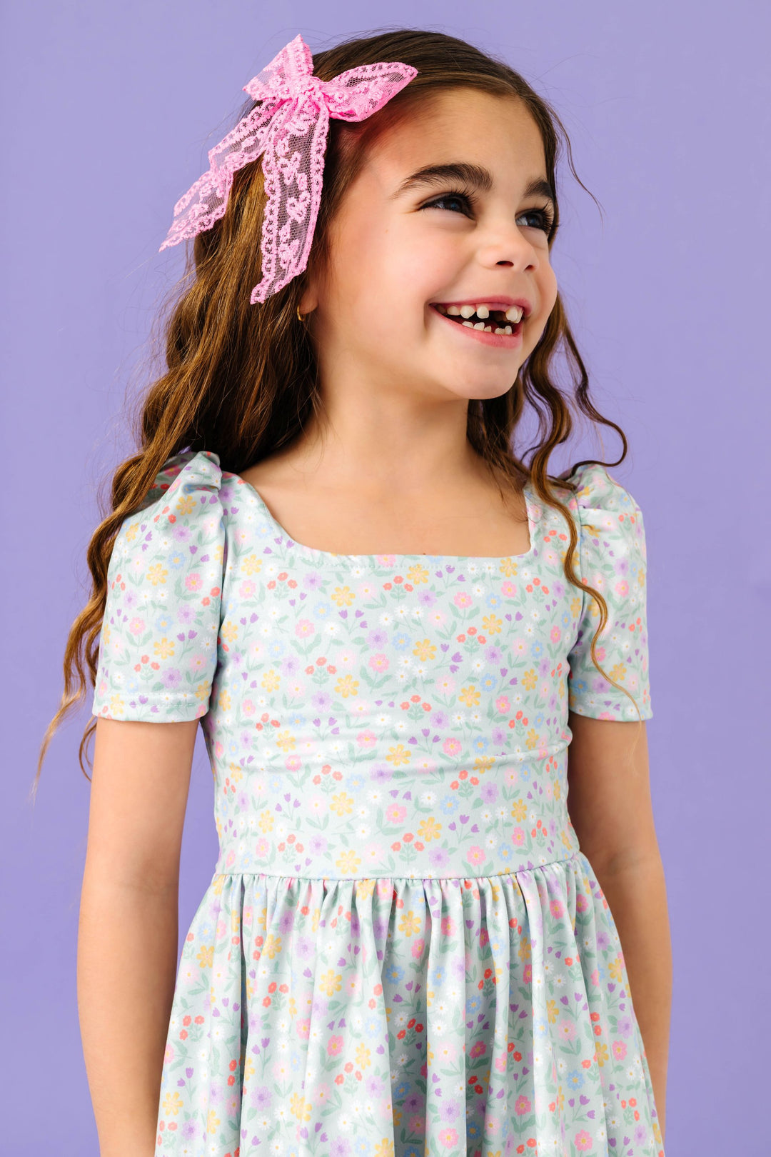 little girl with pink lace hair bow paired with mint green floral twirl dress for spring