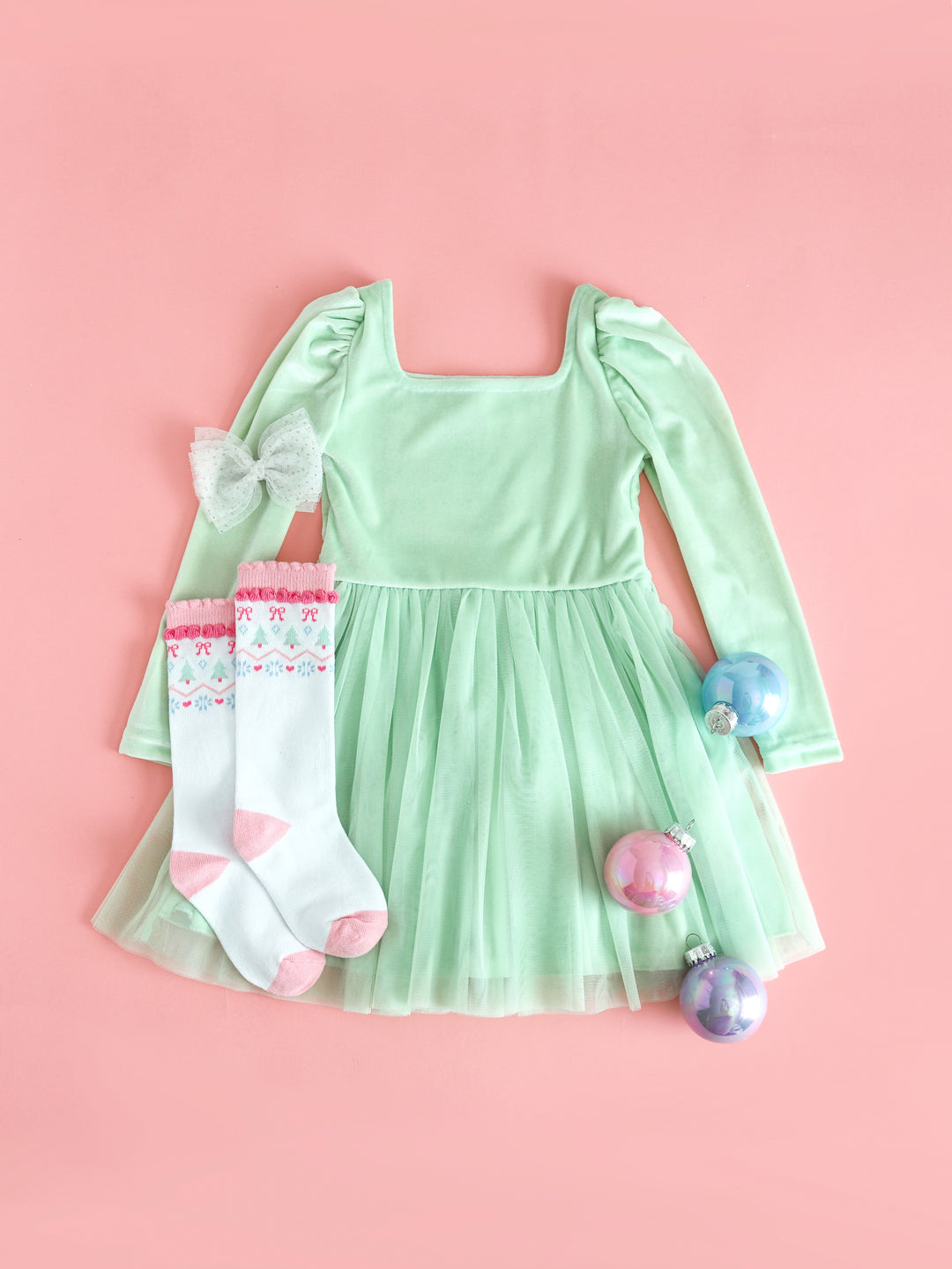 girls mint green velvet long sleeve dress with tulle skirt paired with pastel fair isle print knee socks and sparkly white tutu bow