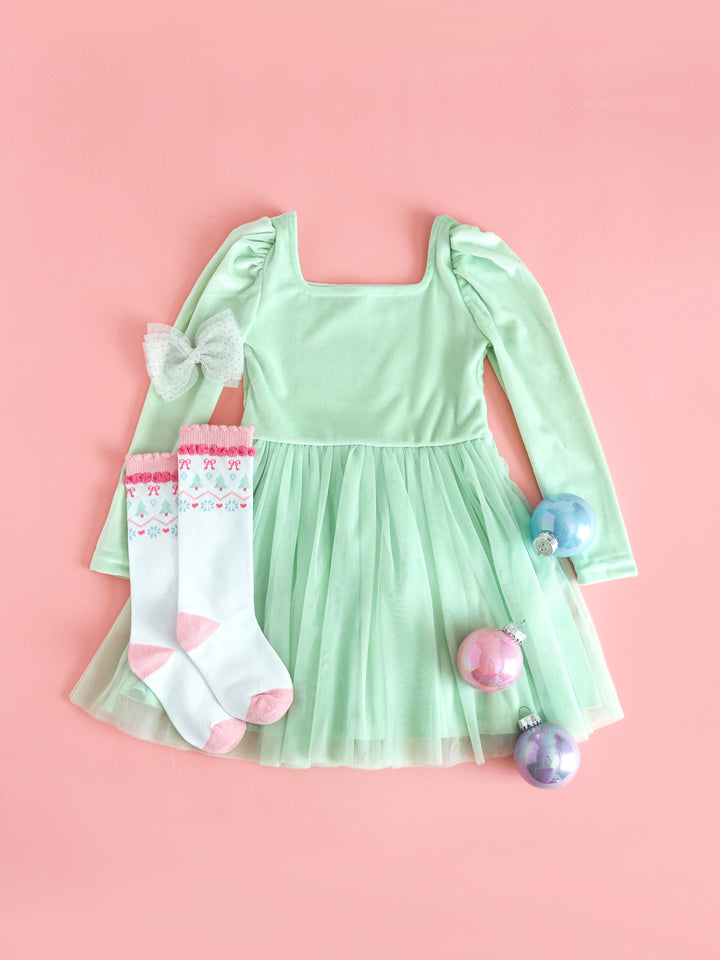 girls mint green velvet long sleeve dress with tulle skirt paired with pastel fair isle print knee socks and sparkly white tutu bow