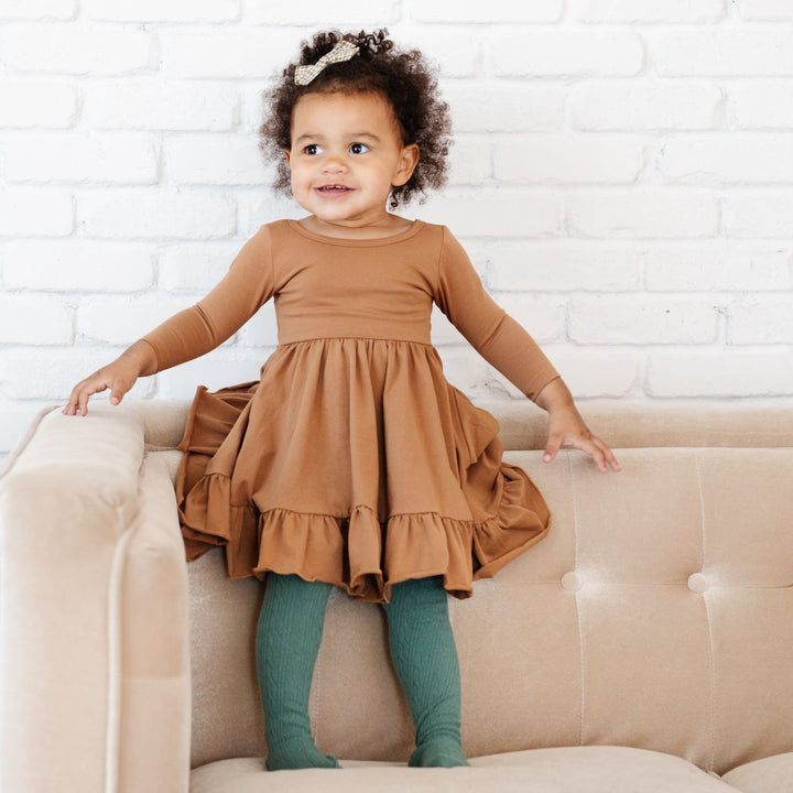 little girl wearing mocha brown party dress with pacific blue tights