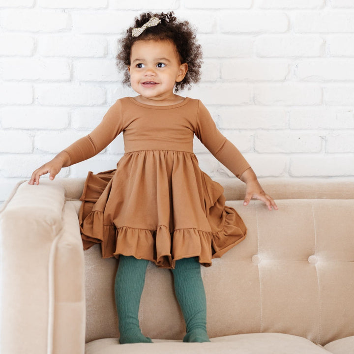 little girl wearing pacific tights with mocha brown twirl dress