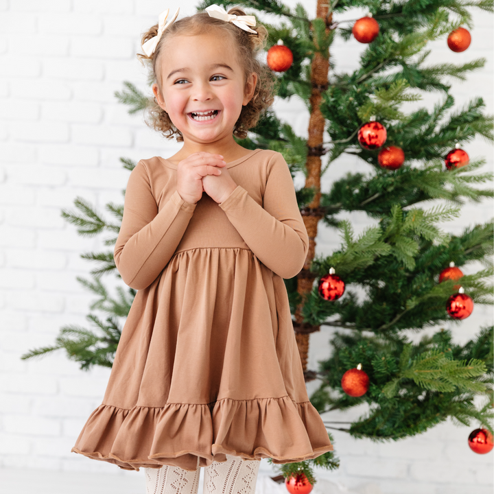 girl in long sleeved mocha brown twirl dress at christmas