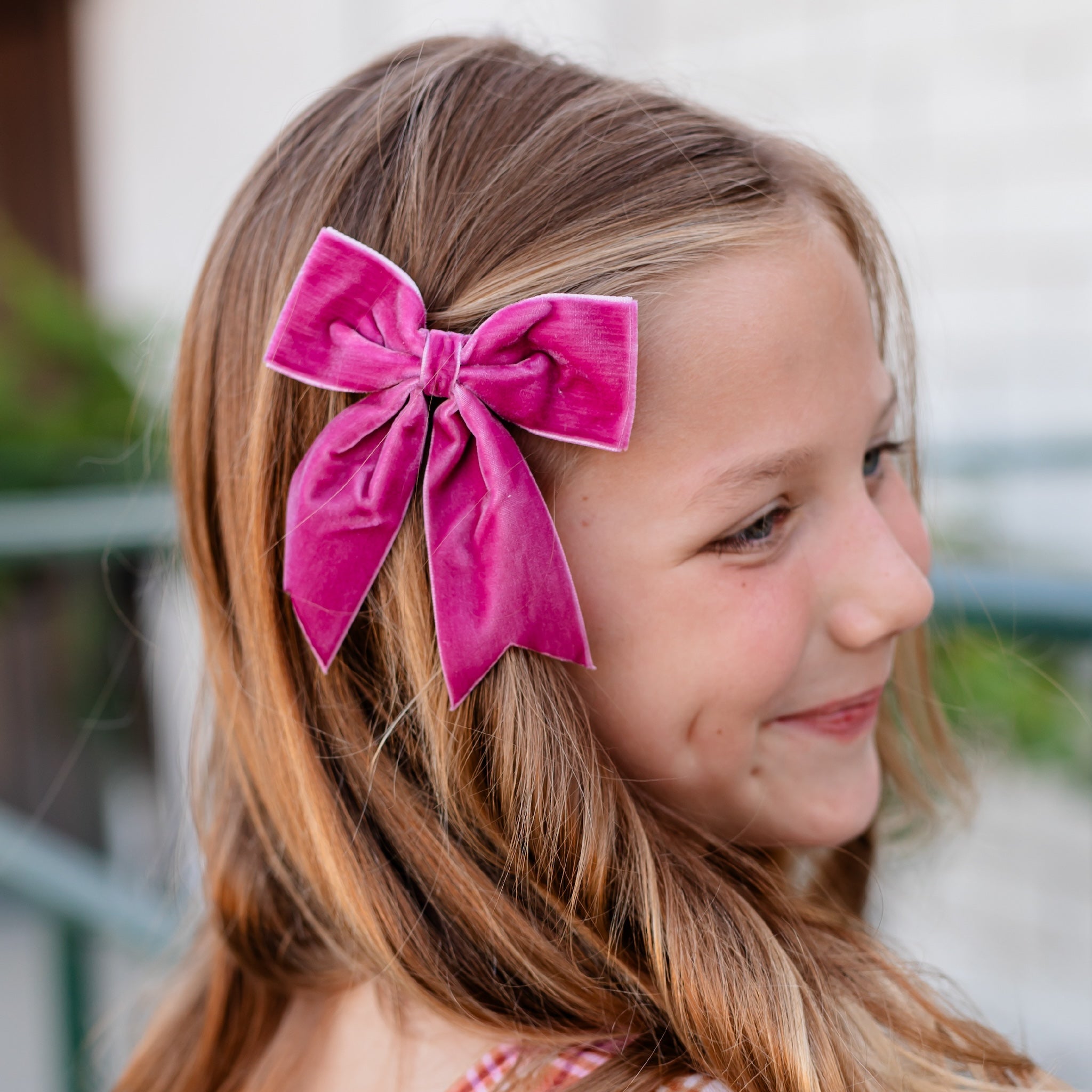 little girl with fall pink velvet ribbon bow on clip with dovetail