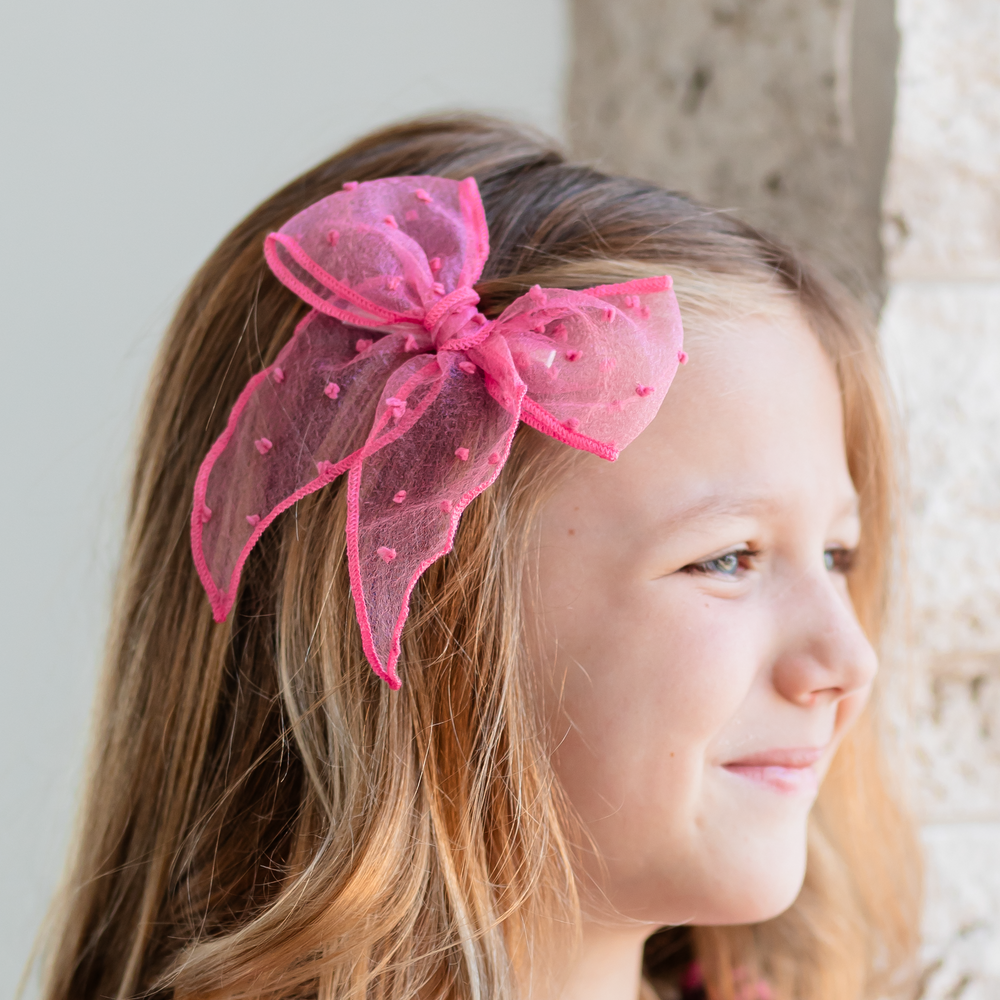girl wearing mulberry pink sheer mesh dot hair bow
