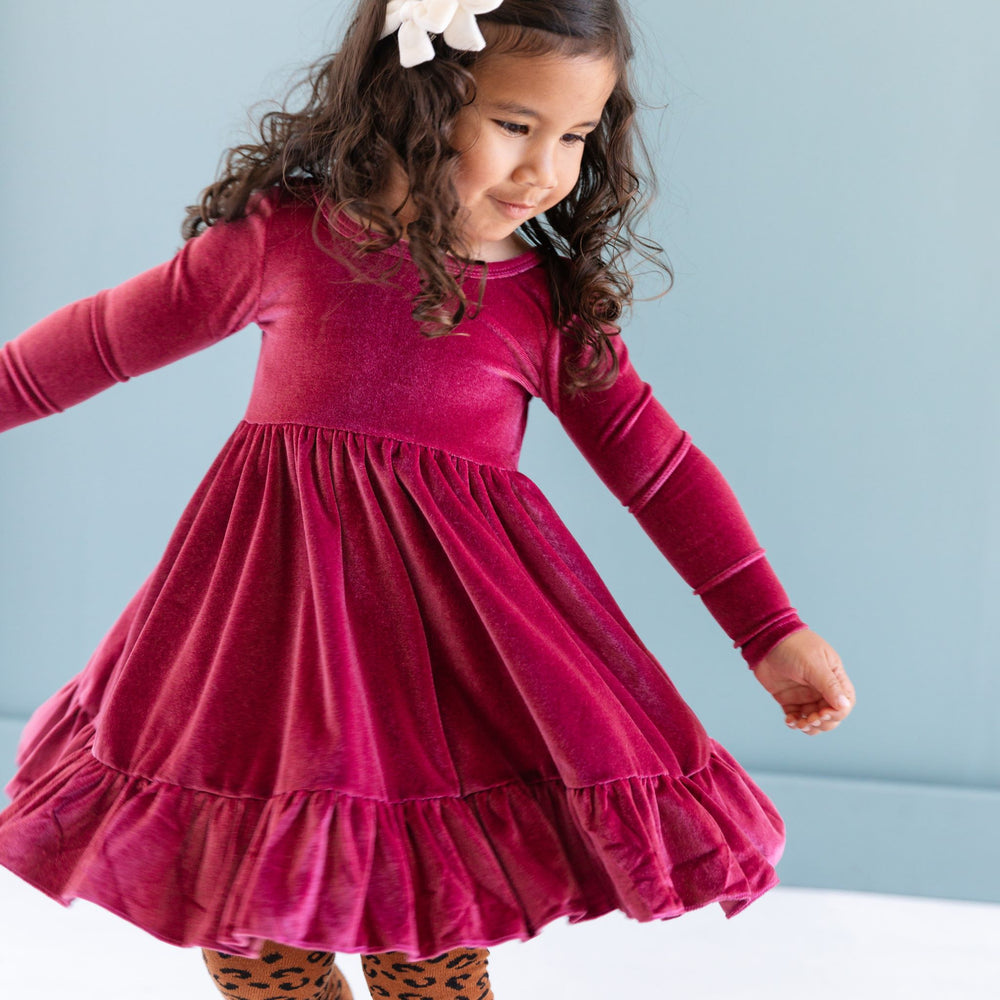 little girl in long sleeve fall pink twirl dress, leopard tights and ivory velvet pigtail bows