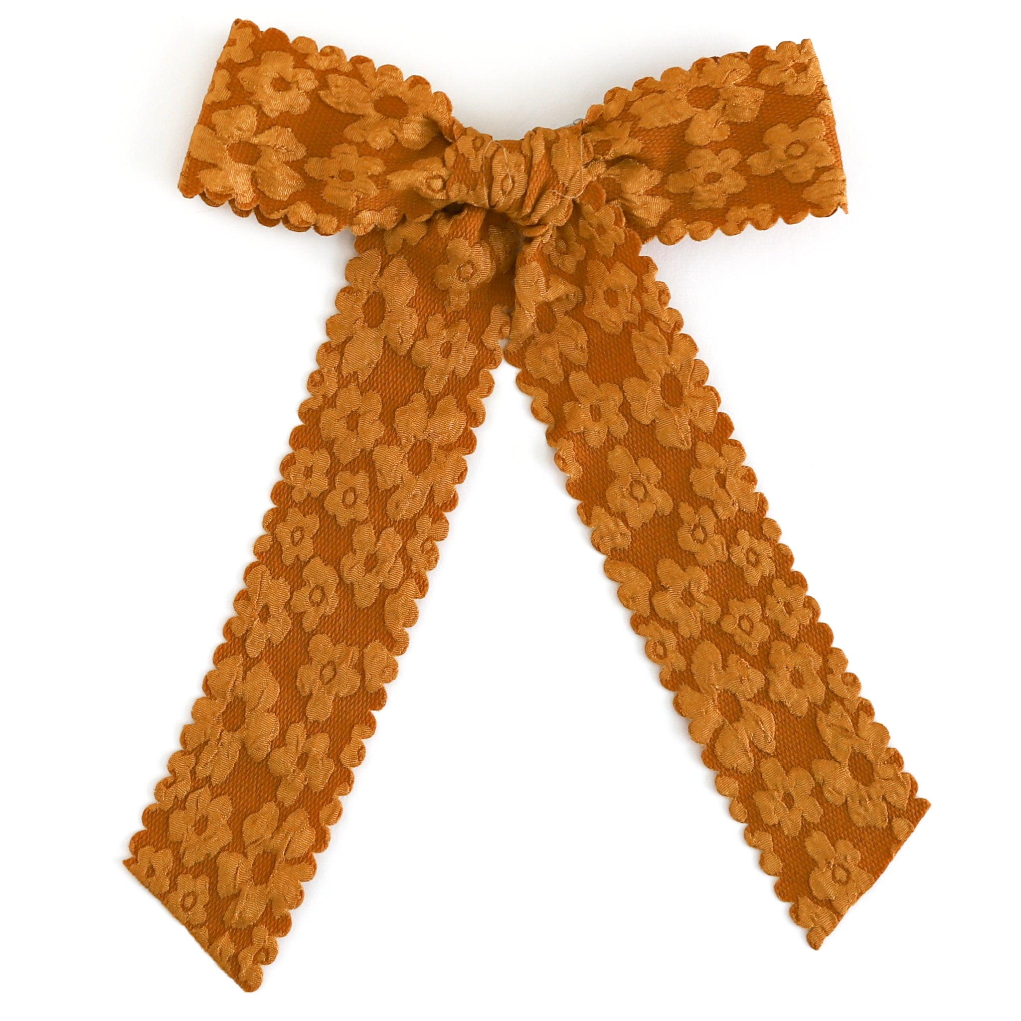 girls mustard ribbon bow with flower pattern and scalloped trim on alligator clip