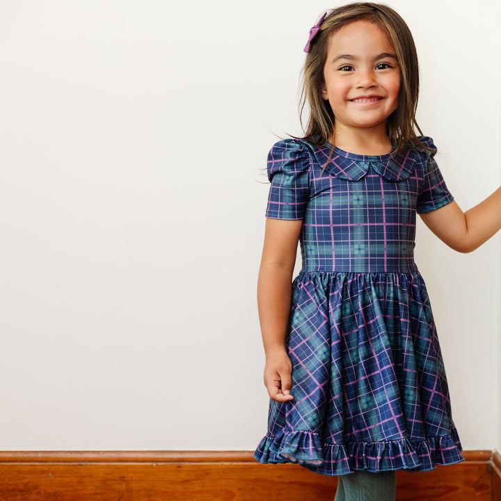 little girl wearing blue plaid party dress