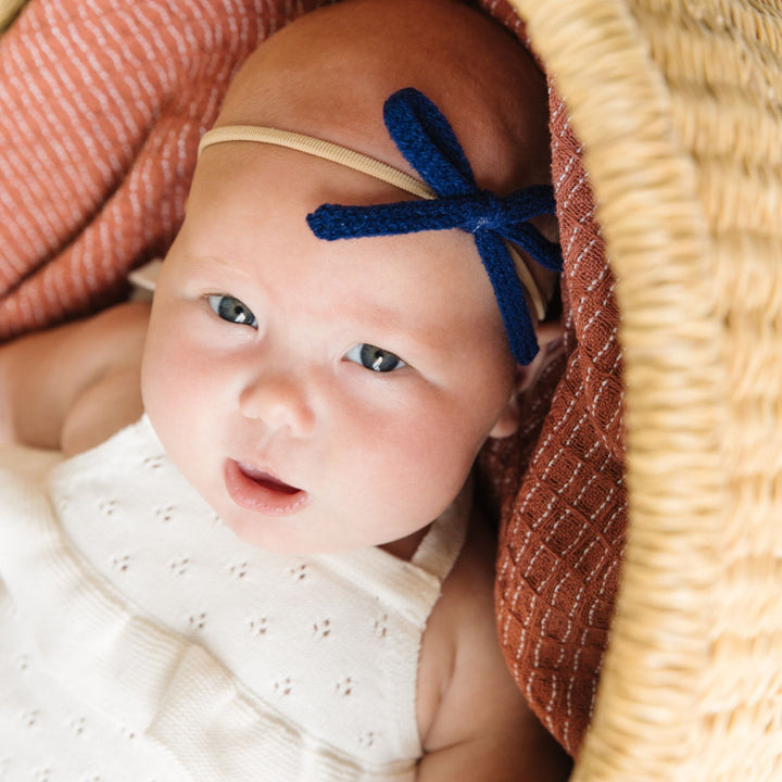 baby girl wearing navy blue yarn baby bow