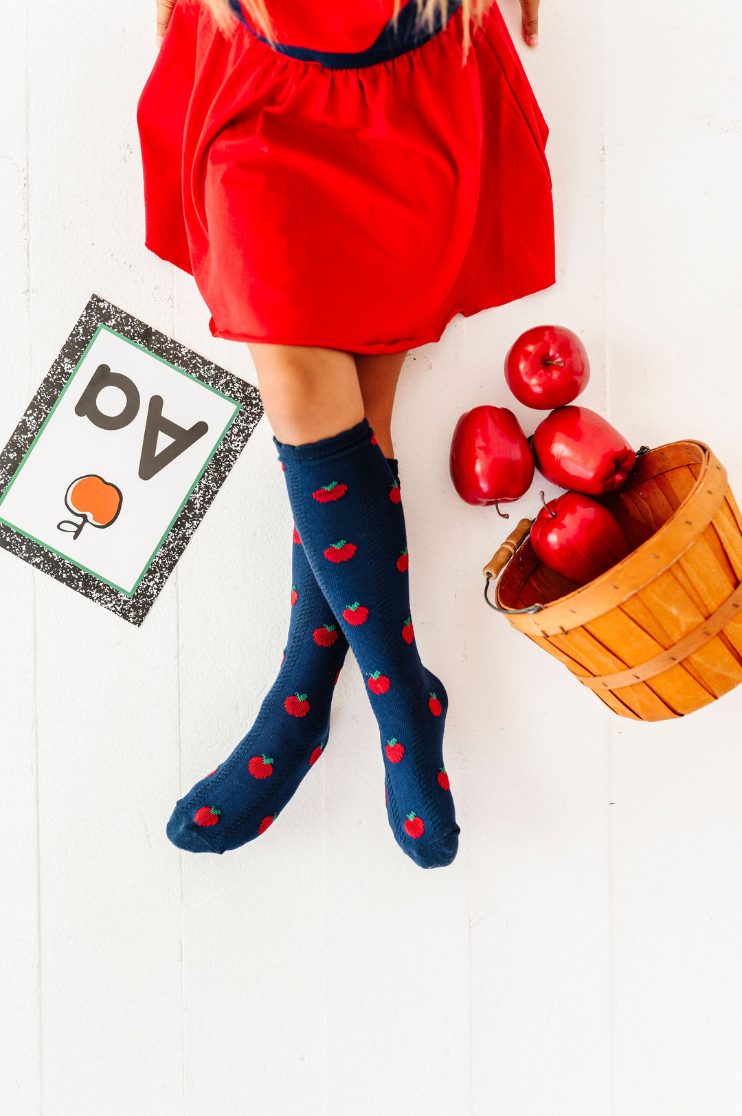 girl wearing navy apple knee high socks