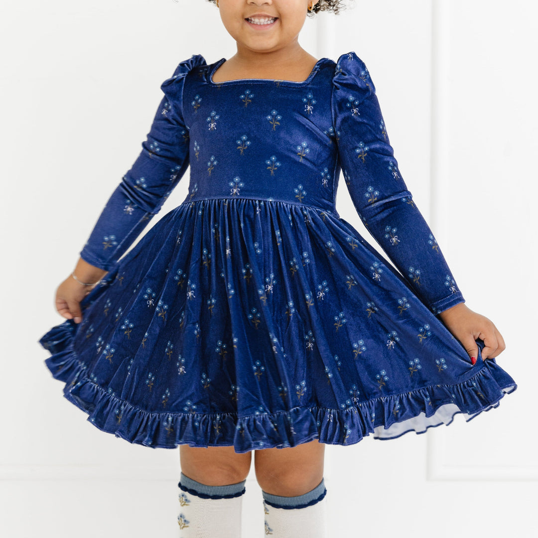 little girl in navy blue velvet long sleeve floral dress and matching floral knee socks for fall